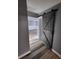 Hallway featuring modern flooring and trendy barn door at 811 Fairview Ave, Altamonte Springs, FL 32701