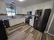 Well-lit kitchen featuring new appliances, white cabinets, modern backsplash, and new flooring at 811 Fairview Ave, Altamonte Springs, FL 32701