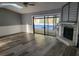 Open living room with a ceiling fan, a fireplace and sliding glass doors leading to a screened pool area at 811 Fairview Ave, Altamonte Springs, FL 32701