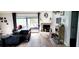 Bright living room featuring a decorative fireplace, stylish flooring, and sliding glass doors to the outdoor space at 811 Fairview Ave, Altamonte Springs, FL 32701