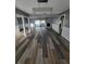 Spacious living area with a view of the pool, featuring modern flooring and stylish lighting fixture at 811 Fairview Ave, Altamonte Springs, FL 32701