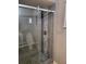 Updated shower with glass door, stone flooring, and modern fixtures at 811 Fairview Ave, Altamonte Springs, FL 32701