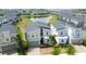 Aerial view featuring lush greenery, a pond, and several neatly arranged houses at 8912 Cabot Cliffs Dr, Davenport, FL 33896