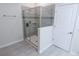Modern bathroom featuring a glass-enclosed shower with gray tile surround and built-in shelving at 8912 Cabot Cliffs Dr, Davenport, FL 33896