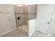 Modern bathroom featuring a glass-enclosed shower with gray tile surround and built-in shelving at 8912 Cabot Cliffs Dr, Davenport, FL 33896
