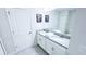Bright bathroom featuring a double vanity, modern fixtures, and neutral decor at 8912 Cabot Cliffs Dr, Davenport, FL 33896
