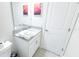 A powder room featuring a toilet and vanity with a large mirror at 8912 Cabot Cliffs Dr, Davenport, FL 33896