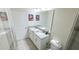 Bathroom with double vanity, large mirror, and plenty of counter space at 8912 Cabot Cliffs Dr, Davenport, FL 33896