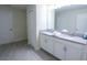 Bright bathroom featuring a double vanity with a neutral countertop at 8912 Cabot Cliffs Dr, Davenport, FL 33896