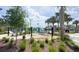 Community playground with hammocks and palm trees, a vibrant space for relaxation and fun at 8912 Cabot Cliffs Dr, Davenport, FL 33896