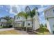 Modern two-story house with palm trees, a grey garage, and tidy front yard landscaping at 8912 Cabot Cliffs Dr, Davenport, FL 33896