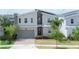 Modern two-story home showcases clean lines, a brick paver driveway, and a spacious two-car garage at 8912 Cabot Cliffs Dr, Davenport, FL 33896