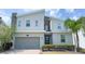 Contemporary two-story home featuring a stone accent wall and well-manicured landscaping at 8912 Cabot Cliffs Dr, Davenport, FL 33896
