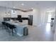 Open kitchen with an island, pendant lighting, stainless steel appliances, and access to the entryway at 8912 Cabot Cliffs Dr, Davenport, FL 33896