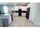 Bright kitchen with white cabinets, black appliances, tile backsplash, and stylish pendant lighting at 8912 Cabot Cliffs Dr, Davenport, FL 33896
