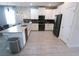 Bright kitchen with white cabinets, black appliances, tile backsplash, and stylish pendant lighting at 8912 Cabot Cliffs Dr, Davenport, FL 33896