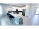 Modern kitchen with island, pendant lights, stainless steel appliances and sleek cabinets, perfect for entertaining at 8912 Cabot Cliffs Dr, Davenport, FL 33896
