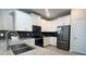 Modern kitchen features granite countertops, an island with sink, and stainless steel appliances at 8912 Cabot Cliffs Dr, Davenport, FL 33896