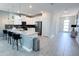 Open kitchen with an island, pendant lighting, stainless steel appliances, and access to the entryway at 8912 Cabot Cliffs Dr, Davenport, FL 33896