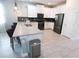 Bright kitchen features a spacious island, stainless appliances, and modern white cabinets at 8912 Cabot Cliffs Dr, Davenport, FL 33896