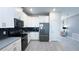 Kitchen featuring white cabinets, stainless steel appliances, and tile flooring with a view to the living space at 8912 Cabot Cliffs Dr, Davenport, FL 33896
