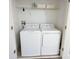 Laundry room with modern washer and dryer, overhead shelving, and ample space at 8912 Cabot Cliffs Dr, Davenport, FL 33896