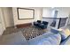 Upstairs living area with a large white screen, decoratively bricked wall, and comfortable seating at 8912 Cabot Cliffs Dr, Davenport, FL 33896
