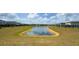 Picturesque community pond surrounded by lush greenery and well-maintained lawns, perfect for leisurely strolls at 8912 Cabot Cliffs Dr, Davenport, FL 33896