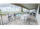 Relaxing screened-in patio featuring a pristine pool, spa, and outdoor dining area at 8912 Cabot Cliffs Dr, Davenport, FL 33896