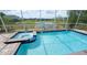 Inviting screened-in pool and spa with scenic water view, perfect for relaxation and entertaining at 8912 Cabot Cliffs Dr, Davenport, FL 33896