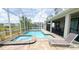 Tranquil pool with spa and outdoor seating enclosed by a screen offers a serene backyard retreat at 8912 Cabot Cliffs Dr, Davenport, FL 33896