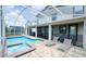 Backyard showcases a screened-in pool, spa, and outdoor seating area perfect for entertaining at 8912 Cabot Cliffs Dr, Davenport, FL 33896