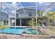Beautiful screened pool and jacuzzi viewed through the lanai from the landscaped backyard at 8912 Cabot Cliffs Dr, Davenport, FL 33896