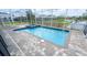Refreshing screened-in pool area with a jacuzzi and brick-paved deck for relaxation at 8912 Cabot Cliffs Dr, Davenport, FL 33896