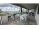 Relaxing screened-in patio featuring a pristine pool, spa, and outdoor dining area at 8912 Cabot Cliffs Dr, Davenport, FL 33896