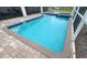 Inviting pool with blue tile accents and a brick paver surround offers a relaxing outdoor space at 8912 Cabot Cliffs Dr, Davenport, FL 33896