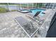 Screened-in patio showcases a tranquil pool with inviting lounge chairs for ultimate relaxation at 8912 Cabot Cliffs Dr, Davenport, FL 33896