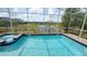 Inviting screened-in pool and spa with scenic water view, perfect for relaxation and entertaining at 8912 Cabot Cliffs Dr, Davenport, FL 33896