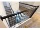 Staircase featuring black metal railings and neutral carpeting at 8912 Cabot Cliffs Dr, Davenport, FL 33896