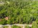 Lush aerial view of a home nestled in dense trees with manicured lawns, providing a private and serene living experience at 102 Wild Plum Ln, Longwood, FL 32779