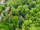 Lush aerial view of a home nestled in dense trees with manicured lawns, providing a private and serene living experience at 102 Wild Plum Ln, Longwood, FL 32779