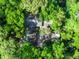 Aerial view showcasing a home surrounded by lush greenery, providing privacy and a serene, natural environment at 102 Wild Plum Ln, Longwood, FL 32779