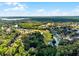 Picturesque aerial view with a lake, golf course, lush trees, and homes creating a scenic and tranquil environment at 102 Wild Plum Ln, Longwood, FL 32779