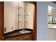 Built-in bar with glass shelves, a sink, and lower cabinets at 102 Wild Plum Ln, Longwood, FL 32779