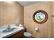Powder room featuring a unique circular stained-glass window and blue wallpaper at 102 Wild Plum Ln, Longwood, FL 32779