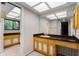Bathroom with a large countertop, a sink, light-up ceiling tiles, and lots of storage underneath the sink and countertop at 102 Wild Plum Ln, Longwood, FL 32779