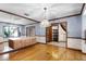 Dining room featuring hardwood floors, mirror wall, and access to the staircase at 102 Wild Plum Ln, Longwood, FL 32779