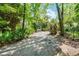 Long gravel driveway to home, surrounded by natural landscaping and trees at 102 Wild Plum Ln, Longwood, FL 32779