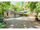 Sprawling single story brick home featuring an attached three car garage and long driveway at 102 Wild Plum Ln, Longwood, FL 32779