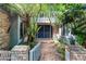 Charming front entrance of home, lush with greenery and a brick pathway at 102 Wild Plum Ln, Longwood, FL 32779